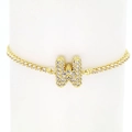 Detail of 18k gold tennis bracelet featuring a sparkling zircon pavé bubble letter W charm - Letter W