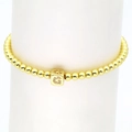 Detail of 18k gold plated beaded bracelet featuring a square crystal-inlaid letter G charm - Letter C