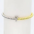 Macro detail of 18k gold plated bubble letter Y charm on two-tone beaded stretch bracelet - Letter Y