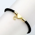 Detail view of black woven rope bracelet with gold heart and zircon letter charm - Letter C