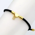 Detail of black woven rope bracelet with gold heart and pave zircon letter E charms - Letter E