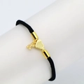 Detail of a black woven heart bracelet with a gold letter A pendant and heart charm - Letter K