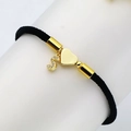 Detail of black woven rope bracelet with gold heart and zircon micro-pave letter S pendant - S