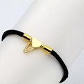 Detail of black woven rope bracelet featuring gold heart charm and micro-inlaid zircon letter V - Letter V