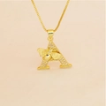 Macro detail of gold letter A pendant with pave zircons and a small 3D bee accent - Letter A