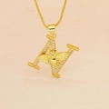 Macro shot of gold letter A pendant with cubic zirconia inlay and a 3D bee detail - Letter N
