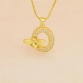 Macro view of gold letter O pendant with pink zircons and small bee detail - Letter O