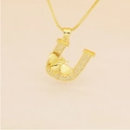 Detailed close-up of gold plated letter U pendant with micro-pave crystals and small bee - Letter U