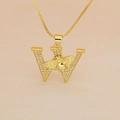 Macro detail of gold letter W pendant with micro-pave crystals and a central 3D honey bee - Letter W