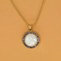 Macro shot of St. Benedict medal pendant with white shell and purple zircon inlay - Purple