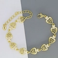 Detailed close-up of golden heart chain bracelet featuring LOVE engraving and zircon stones - Heart LOVE Style (D4)