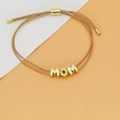 Detail view of woven champagne gold bracelet with MOM letter beads and adjustable closure - MOM Letter Style (C1) / Champagne (C1)