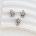 Detailed view of three silver plated ball charms with a unique spiked sphere design - White Gold