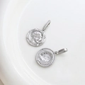 Macro detail of silver coin pendants with portrait relief and sparkling zircon setting - Platinum Color Portrait