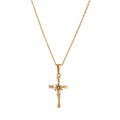 Close-up of golden vintage floral cross pendant with a centered zircon on a cable chain - February