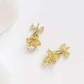 Détail macro de breloques cloches dorées 14 carats avec nœud en zircon pour bijoux - Zircone Blanche / Or 14 carats
