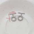 Macro shot of silver flower-shaped OT toggle clasps with cubic zirconia and dimensions - Hollow Petal Design
