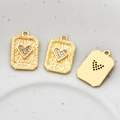 Macro view of gold-plated playing card pendant with cubic zirconia heart and textured finish - Red Heart Style
