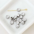 Macro shot of silver flower spacer beads and a gold pin for DIY jewelry making - Hollow Flower Bead (9#)