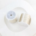 Detail of 14K gold filled jewelry wire on white spools for DIY craft and wire wrapping - Silver (0.4mm / 100m)