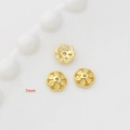 Vista macro di copriperle a fiore dorati da 7mm per accessori gioielli fai-da-te - Placcato Oro 14K Stile 7