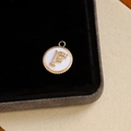 Gold-plated letter F pendant featuring micro-paved zircons and white shell base - Letter F
