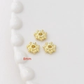 Dettaglio macro di distanziatori a fiore placcati oro 8mm per creazione gioielli - Placcato Oro 14K Stile 22