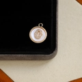 Gold-plated round pendant with inlaid zircon letter O on white mother-of-pearl base - Letter O