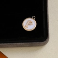 Gold plated pendant with letter P design, shell inlay, and sparkling zircon crystals - Letter P