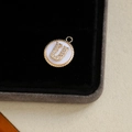Gold plated round letter U pendant with mother of pearl and sparkling zircon stones - Letter U