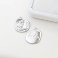 Macro detail of silver owl pendant showing freedom engraving and S925 silver mark - White Gold