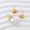 Detailed view of gold plated jewelry caps and baroque style white pearl charms - Gold