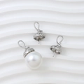 Macro detail of textured silver pendant caps for DIY jewelry with baroque pearls - White Gold