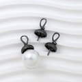 Macro shot of gun-black metal pearl caps with scales pattern for DIY jewelry design - Gunmetal