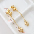 Macro shot showing dimensions of long gold bunny drop earrings on white ceramic base - Gold Rabbit Long Style (AQ0006)