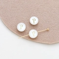 Macro shot of a white shell bead with golden letter P for DIY jewelry making crafts - Letter P (16#P Single Price)