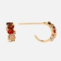 Golden C-shaped earrings with red and orange pear-cut birthstones and crystals - January