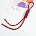 Handwoven reddish-brown paracord keychain with white dashed pattern on white background - Ancorra Red