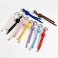 Handwoven leather rope keychains shown in nine vibrant colors with silver metal rings - Braided Random Color
