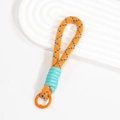 Kurze orangefarbene Handy-Handschlaufe geflochten mit blauen Punkten und Metallring - Orange