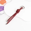 Handcrafted burgundy braided leather keychain featuring a silver round spring ring - Single Color-Ankara Red
