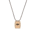 Detailed close-up of a golden tarot pendant with black enamel UFO design and zircon frame - UFO (HSNK23120802D)