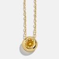 Macro detail of minimalist gold necklace featuring a round brilliant-cut yellow birthstone - November Citrine Yellow (11)