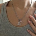 Detail of silver cowboy boot and horseshoe pendants on a twisted rope chain necklace - Boot And Horseshoe Silver