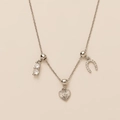 Detailed view of silver heart and horseshoe pendants set with sparkling zircon crystals - Horseshoe Heart - Silver