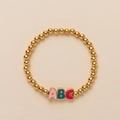 Cute golden beaded stretch bracelet with colorful ABC enamel alphabet letter charms - ABC Lock