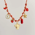 Detail view of woven cord necklace with gold sea turtle, strawberry, and heart charms - Turtle Red Rope Style