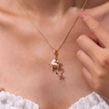 Gold necklace with pink baroque heart pearl and purple star pendant on model - Starfish Necklace