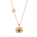 Detailed close-up of golden spinning flower pendant with a sparkling red zircon center stone - January Style