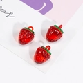 Three red strawberry pendant charms in transparent resin with green leaves and metal loops - Strawberry Shape / Transparent Red